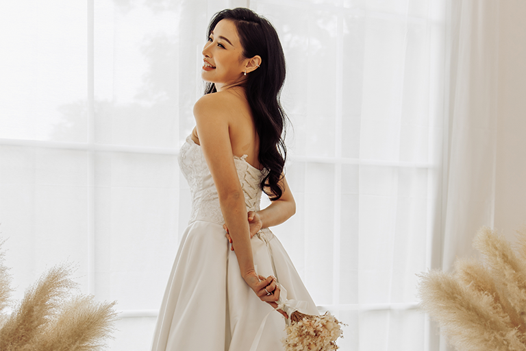 Bride standing in a white wedding dress Bride standing in a white wedding dress